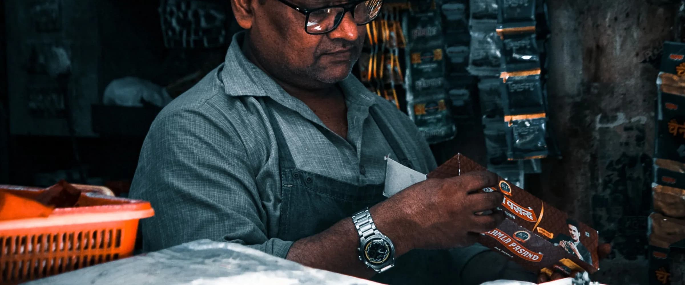 A shopkeeper checking stock behind the counter