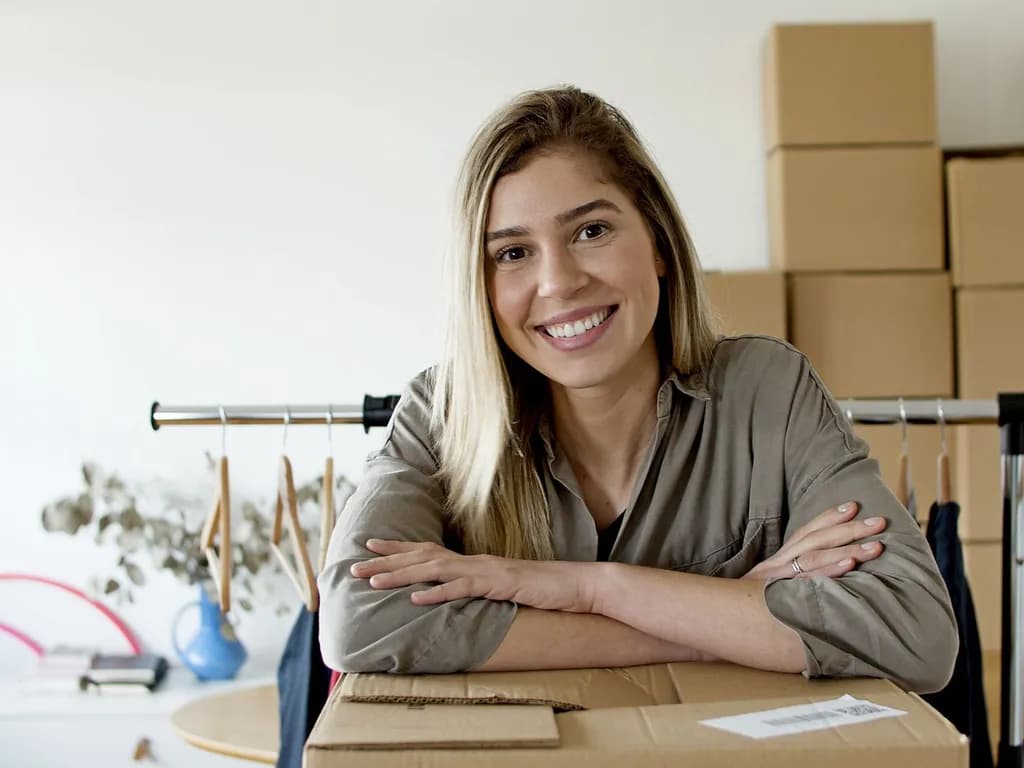 An owner packing customer orders at her workbench