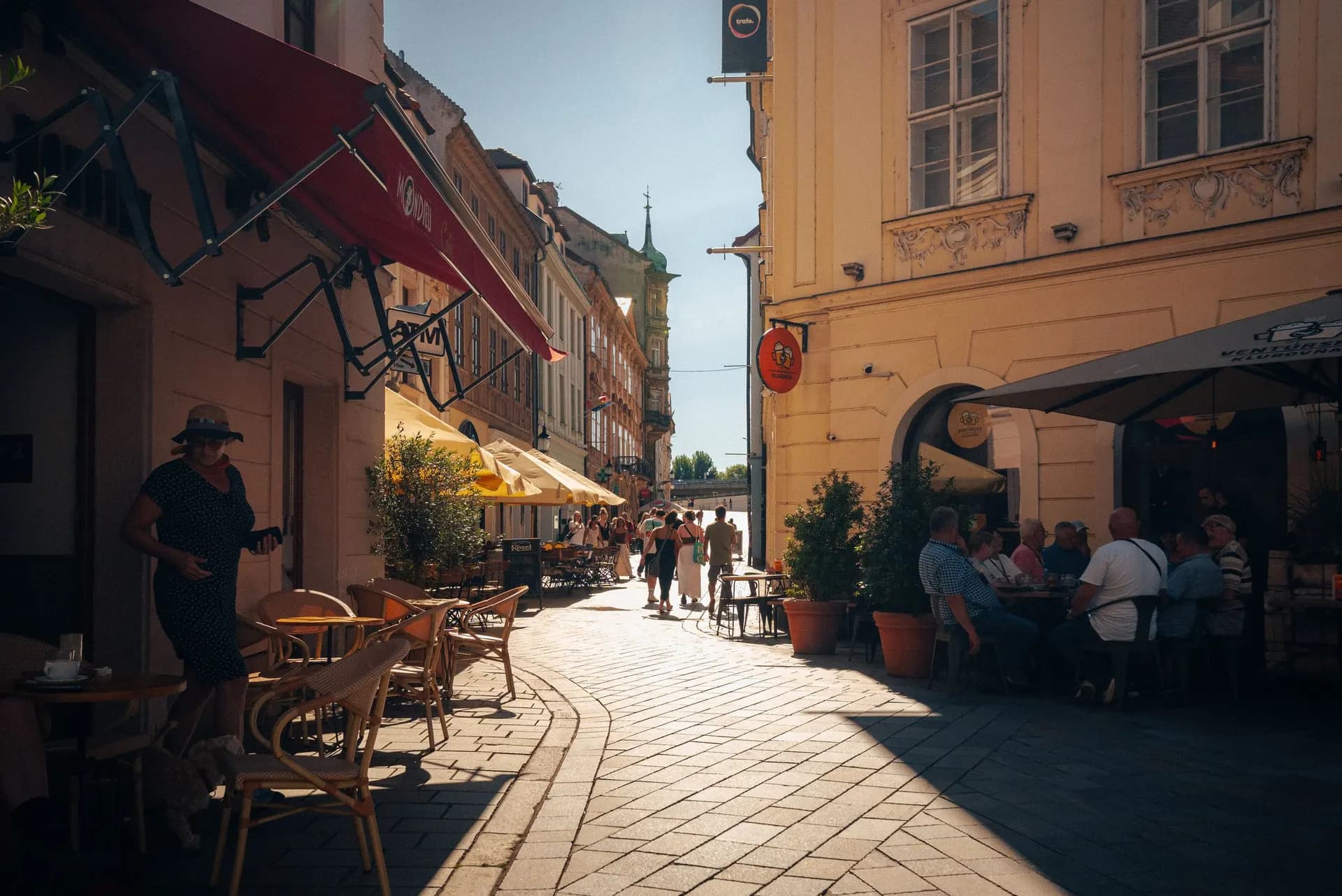 Tables outside an independent café on a cobbled street